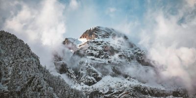 Majestic snowy peak surrounded by winter clouds in the Tyrolean Alps.