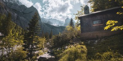 Charming mountain cabin nestled in the Bavarian Alps with lush greenery and breathtaking views.